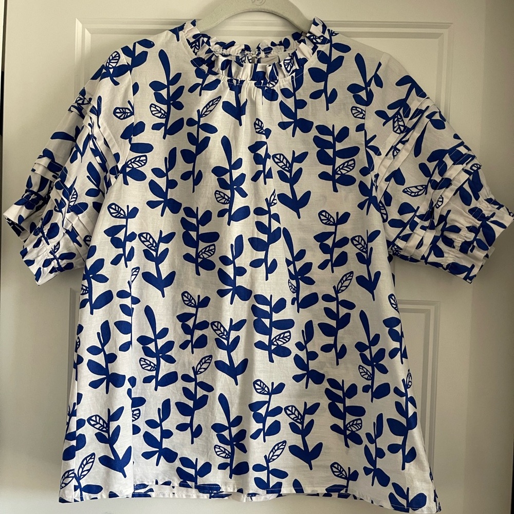 Blue and white mod floral ruffle neck top